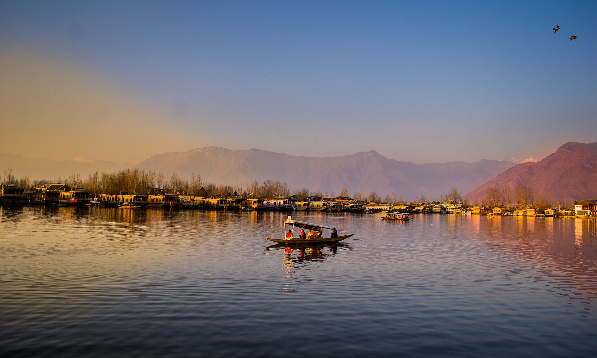 Dal Lake, Srinagar, with mountains reflected in still water